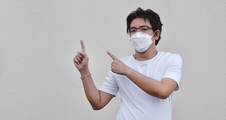 Asian men wearing mask for protect coronavirus, PM2.5 dust and air pollution  concept. - 451463248
