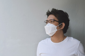 Asian men wearing mask for protect coronavirus, PM2.5 dust and air pollution  concept.