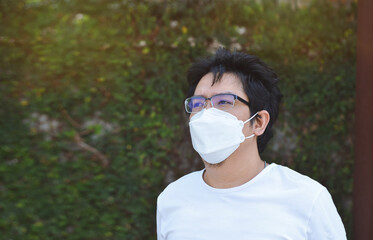 Asian men wearing mask for protect coronavirus, PM2.5 dust and air pollution  concept. - 451463268