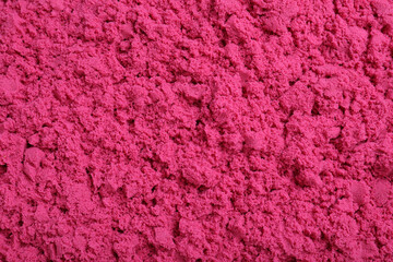 Pink kinetic sand as background, closeup view