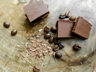 Pieces of chocolate and coffee beans on the table