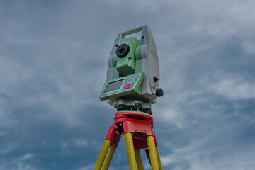 Machine for surveyors with blue sky and green trees in sunny day