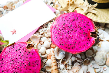 Exotic fruits. dragon fruit and mango on a background of seashells 
