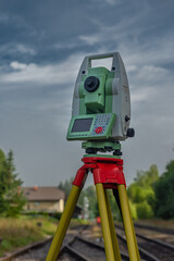 Machine for surveyors with blue sky and green trees in sunny day