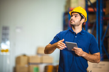 professional warehouse industrial manager using tablet to checking a distribution stock, business man have a inventory work in storage shipping factory, job on storehouse technology