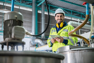 professional inspection control scientist in uniform are working for fruit juice production industry in food manufacturing factory, water drink checking and beverage research in laboratory