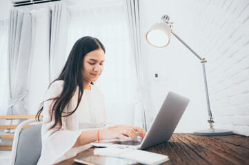 young woman talking with video conference at home, online remote communication technology to call by laptop computer on cyberspace, lifestyle of female person happy to work and keep distant isolated