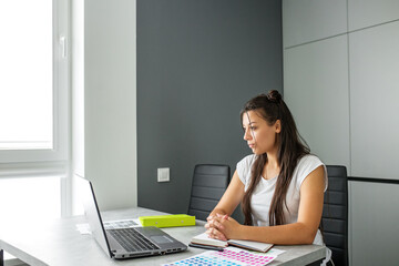 A young student is studying online. Office worker. Computer techologies.