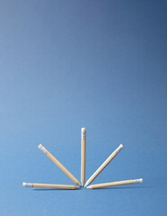 wooden pencils , levitating arranged in half ball. minimal creative office / school / business concept. blue background.