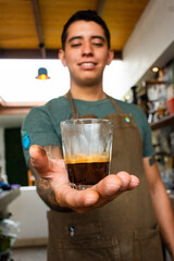 A barista holding a coffee cup