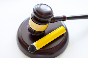 brown gavel and electronic cigarette on a white background, concept of danger and the ban of electronic cigarettes and vape