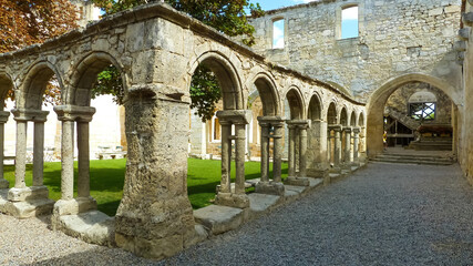 Fototapeta na wymiar Saint-Emilion (Cloitre des cordeliers), France - September 9. 2016: View into courtyard of monastery from 14th century with pillars and arches