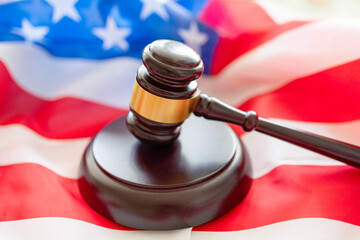 brown gavel against the background of the American flag, the concept of a fair judicial system in...