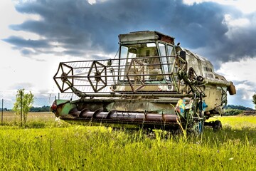 An old abandoned combine harvester in the Czech countryside. Agricultural machinery. Grain harvest.