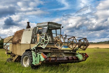 An old abandoned combine harvester in the Czech countryside. Agricultural machinery. Grain harvest.