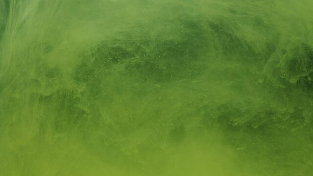 Yellow ink acrylic paint mixing in water, swirling softly underwater. Colored citric acrylic cloud of paint in aquarium. Slow motion abstract smoke explosion animation. Beautiful art background