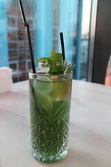 in a cafe, restaurant, there is a glass with a cocktail on the table