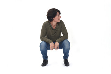 front view of a woman sitting squatting and look away on white background