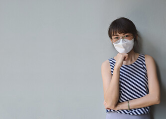 Asian women Portrait  wearing mask and standing with arms folded,  protect coronavirus, PM2.5 dust and air pollution  concept.