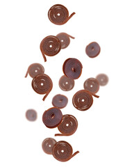 Delicious fruit leather rolls falling on white background