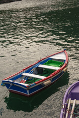 Fototapeta na wymiar Fishing boat of many colors on the Asturian coast