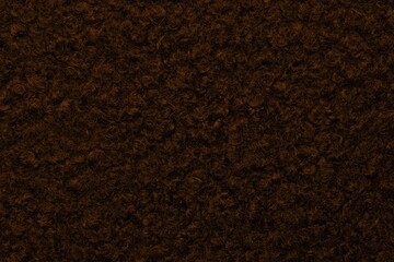 Brown astrakhan background from warm woolen fabric