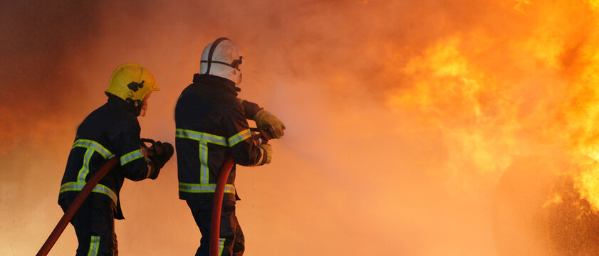 industrial fire, fire fighters fighting large industrial fire 
