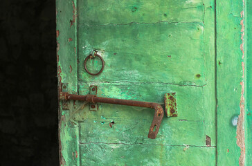 Antique open green door in a Tuscan house