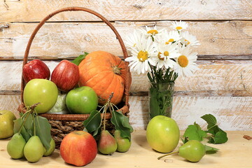 Thanksgiving background, harvest concept, autumn composition with fruits, natural berries, pumpkins, pears, apples, flowers on a wooden background,