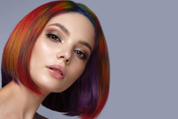 Beautiful woman with multi-colored hair and creative make up and hairstyle. Beauty face.
