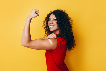 a black African American woman is vaccinated against covid and is very happy about it. the joy of having a vaccine made. - obrazy, fototapety, plakaty