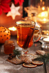 Glass of Christmas tea with cloves and cinnamon.