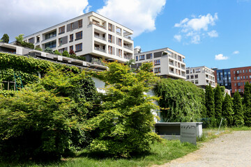 KRAKOW,POLAND - MAY 27, 2021: A modern apartment building surrounded by old, historic buildings in an industrial area, Zablocie district