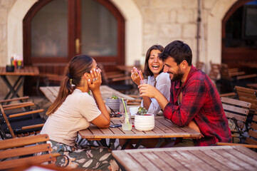 Group of friends enjoying in cafe together