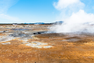 Geothermal area dotted with steaming mud pots on a clear summer day. Hverir, Iceland.