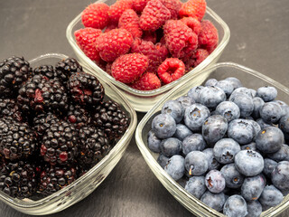 bowls with assorted forest berries top view