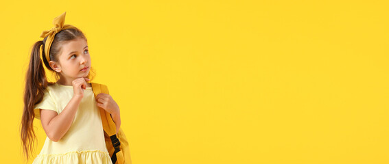 Cute little schoolgirl on color background with space for text