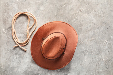 Cowboy hat and lasso on grunge background - obrazy, fototapety, plakaty