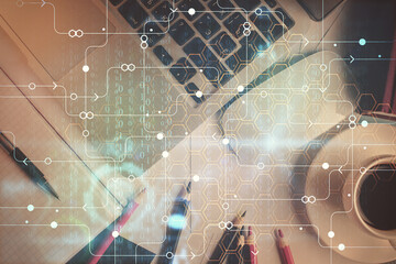Double exposure of data drawing hologram over topview of study desk background with computer. Concept of Ai.