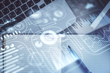 Technology hologram drawing over computer on the desktop background. Top view. Double exposure. Tech concept.