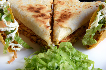 delicious mexican food tacos, guacamole, quesadillas, chilli, tortilla, burritos isolated on black background.