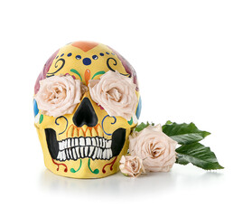 Painted human skull for Mexico's Day of the Dead (El Dia de Muertos) and flowers on white background