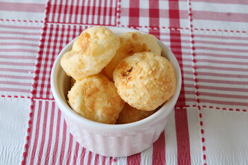 Cheese Bread in a white ramekin in a red chess background