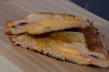 Cheese and Ham sandwich on a wooden plate. Traditional Brazilian sandwich called Misto Quente