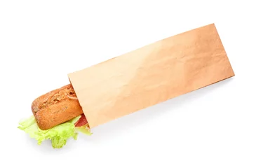 Fototapeten Bag with tasty ciabatta sandwich on white background © Pixel-Shot