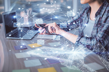 Double exposure of woman hands typing on computer and flying envelop drawing. E-Mail concept.