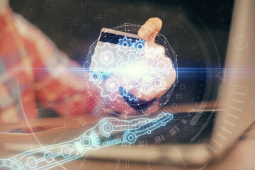 Double exposure of man hands holding a credit card and data theme drawing. E-commerce and technology concept.