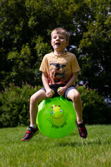 Boy bouncing on a space hopper