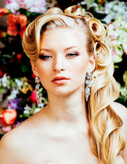 beauty emotional blond bride in luxury interior dreaming, crazy complicate hairstyle, many flowers