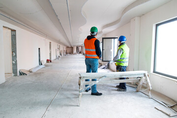 Workers standing in the rebuilding of  the office.